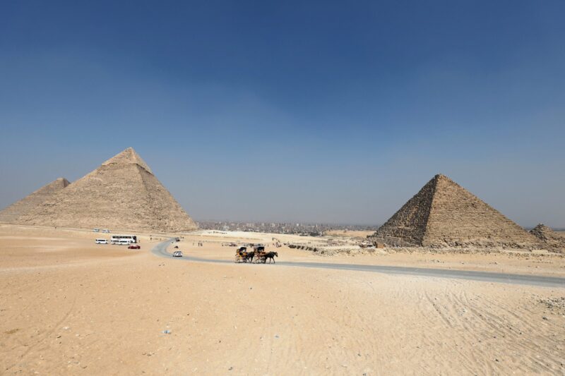 Tourists ride in horse carts in the Giza pyramids area, on the outskirts of Cairo